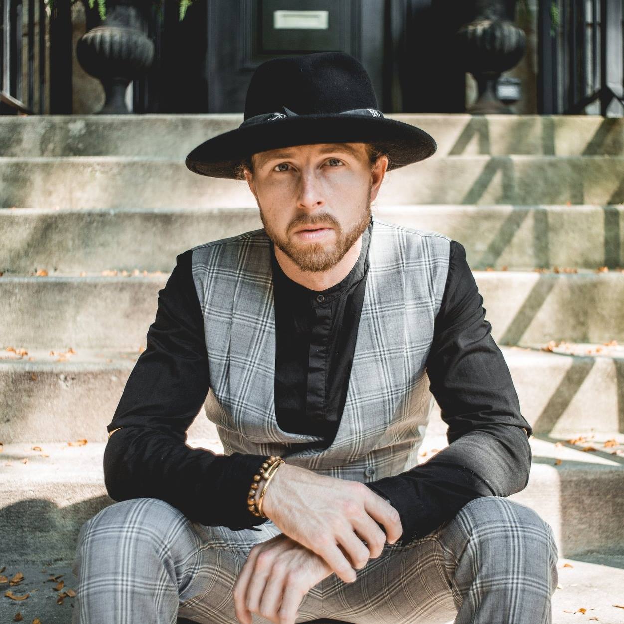 dapper guy sitting on stairs