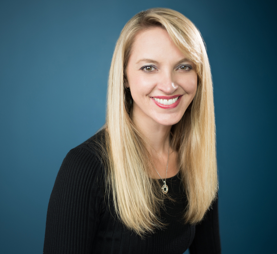 Laura blonde blue background headshot