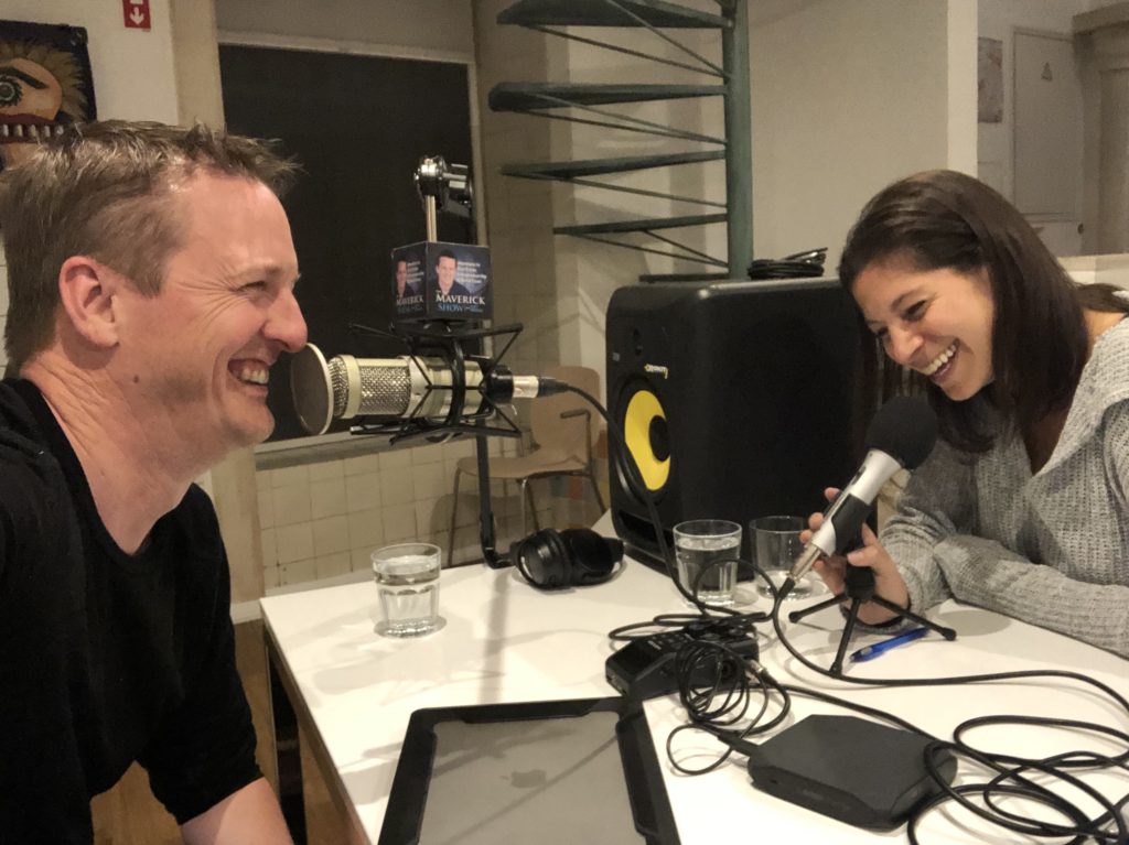 Marisa Meddin and Matt smiling with a podcast setup