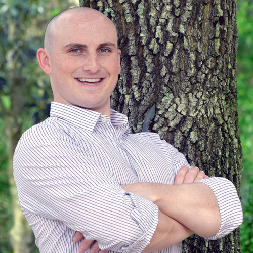 guy smiling tree background