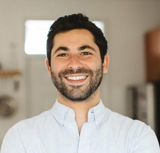 man with a beard wearing white button down shirt