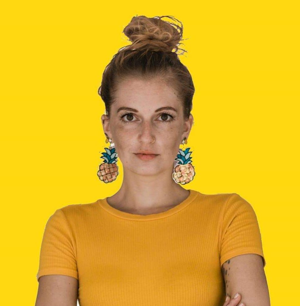 woman wearing big pineapple earrings