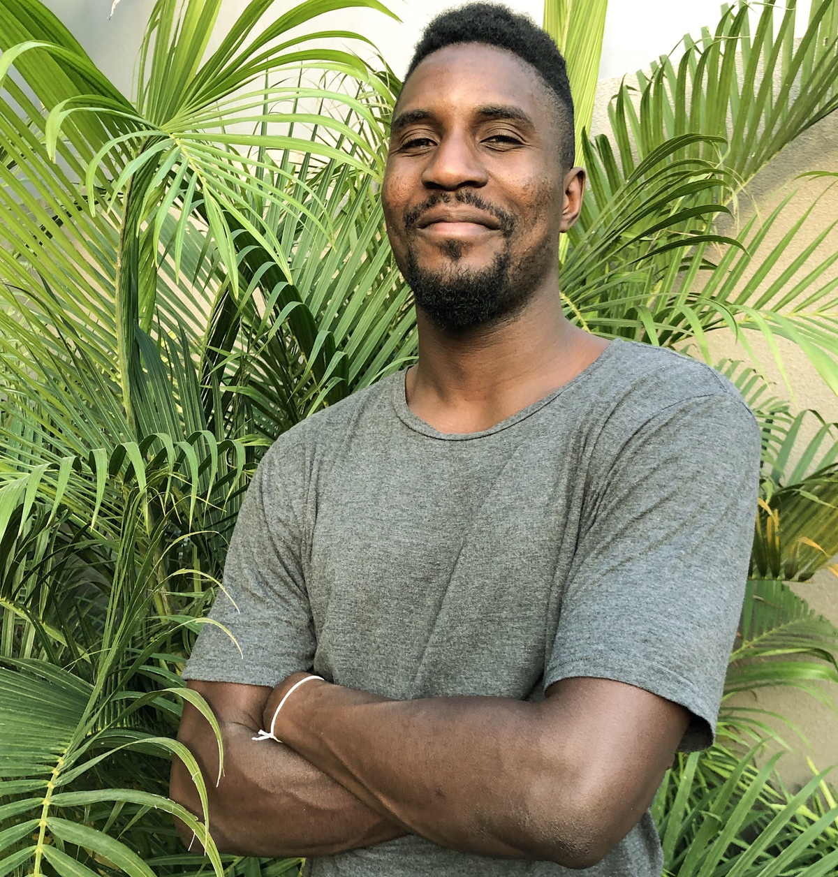 man with a plant behind him