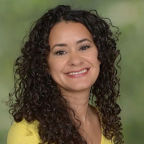 headshot of a woman with curly hair