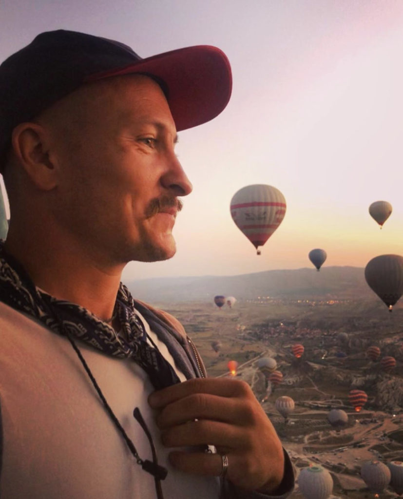 man with hot air balloons at the back