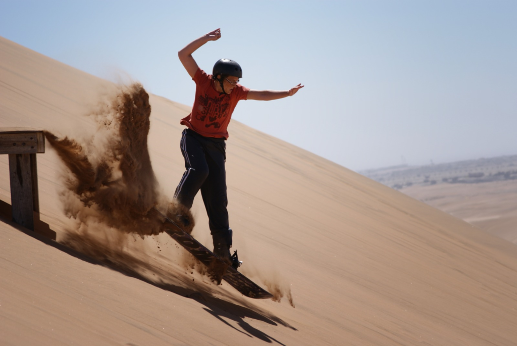 a man sand boarding