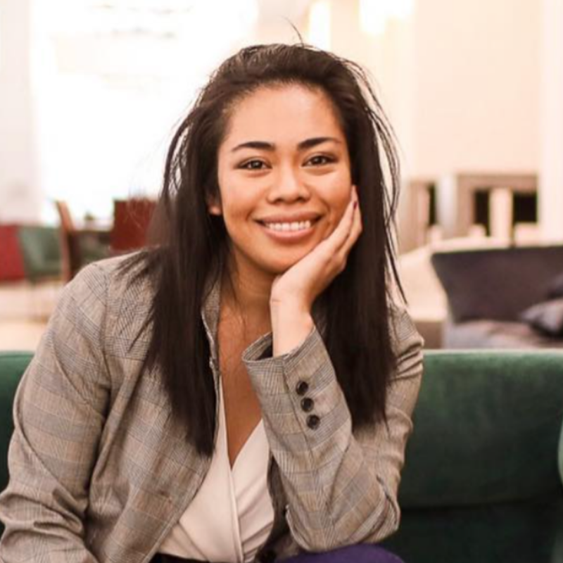 headshot of a woman wearing gray blazer