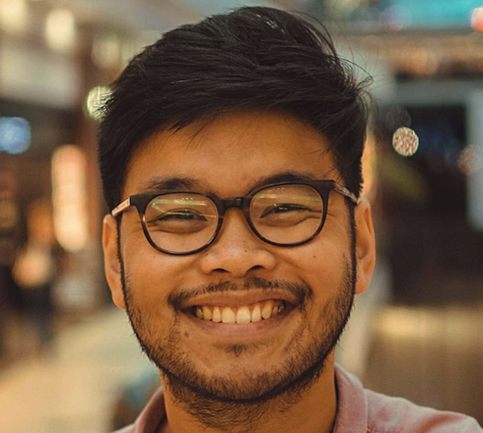 headshot photo of a man smiling