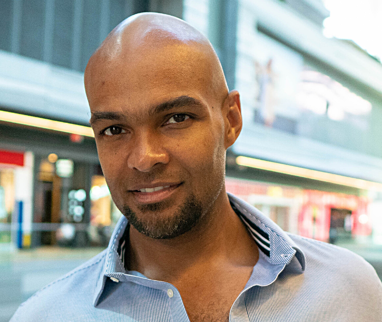 headshot photo of a man smiling