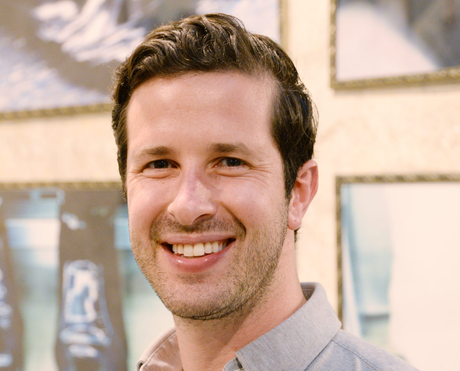 headshot photo of a man smiling