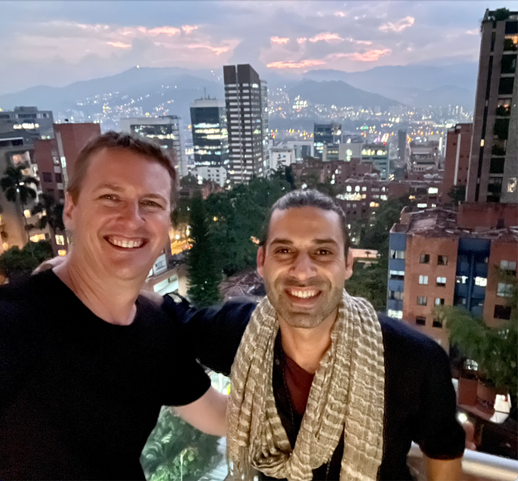 Tarek Kholoussy and Matt smiling from a balcony