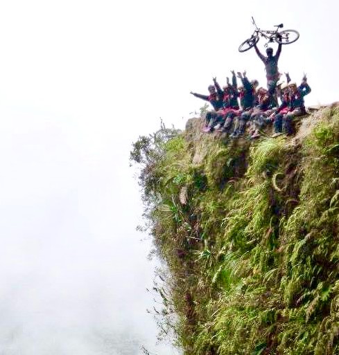 team biking sitting on a cliff